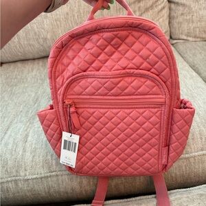 Vera Bradly small backpack. Coral color on outside, floral print inside.